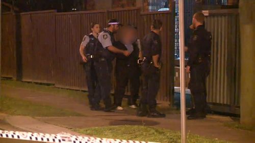 Police spoke to a man outside the home where Yilmaz was murdered. (9NEWS)