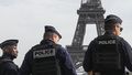 Police officers patrol the Trocadero plaza near the Eiffel Tower in Paris, Tuesday, Oct. 17, 2023.