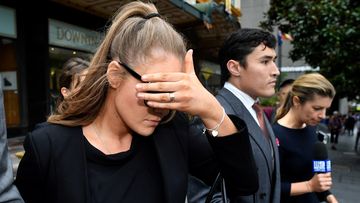 Sarah Jane Chisholm Rogers, 24, covers her face as she leaves court in Sydney.