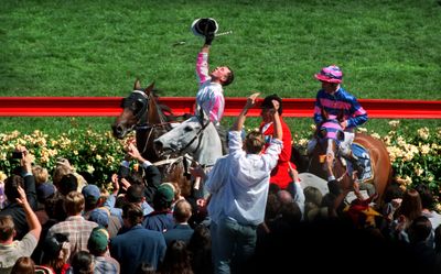 Might And Power ridden by Jim Cassidy who salutes the sky as he heads back into the mounting yard