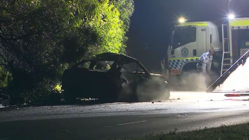 The burnt-out wreck of the vehicle is towed from the scene. (9NEWS)