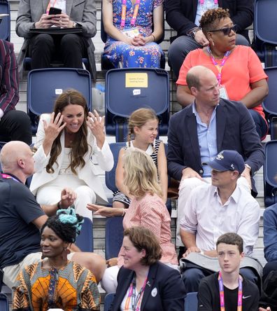 Kate, Duchess of Cambridge, interacts with spectators, as Britain's Prince William and Princess Charlotte watch the Women's Pool A hockey match between India and England at the Commonwealth Games in Birmingham, England, Tuesday, Aug. 2, 2022 