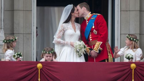 Duchess and Prince William sharing the famed balcony kiss on their wedding day.