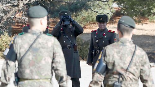 North Korean soldiers glare at their southern counterparts on the border.