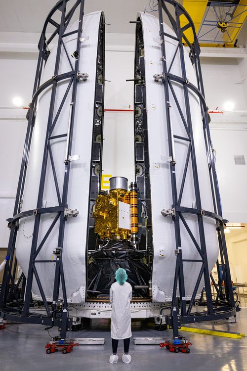 Both halves of the Falcon 9 rocket's protective payload fairing move toward NASA's Double Asteroid Redirection Test (DART) spacecraft on November 16, 2021.