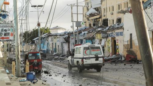 An ambulance drives past a section of the Hayat Hotel, the scene of a militant attack in Mogadishu, Somalia, on August 20, 2022