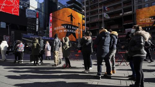 People wait in a long line to get tested for COVID-19 in Times Square, New York.