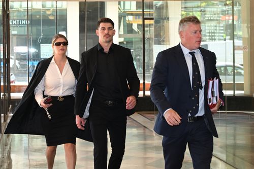 Former NRL player Curtis Scott (centre) arrives at Downing Centre District Court, in Sydney, Wednesday, April 8, 2026.