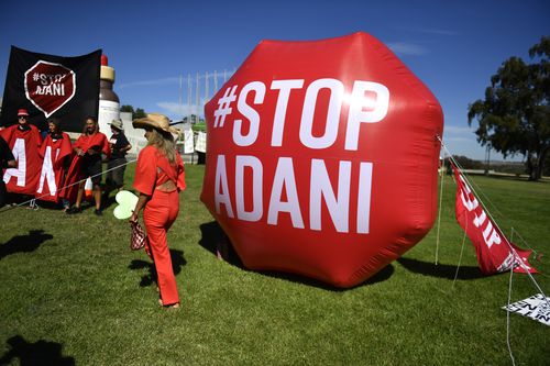 Protesters rallying against the planned Adani coal mine to be built in Queensland took to the lawn of Parliament House today (AAP).