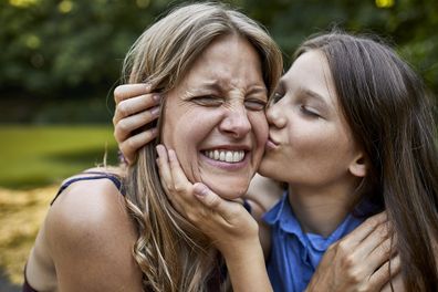 Mother hugging her daughter