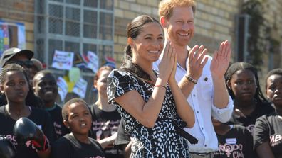 Meghan, left, and Prince Harry, right, greet children and youths on a visit to the Nyanga Methodist Church in Cape Town, South Africa, Monday, Sept, 23,2019.