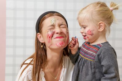 Mum and daughter playing with face paint