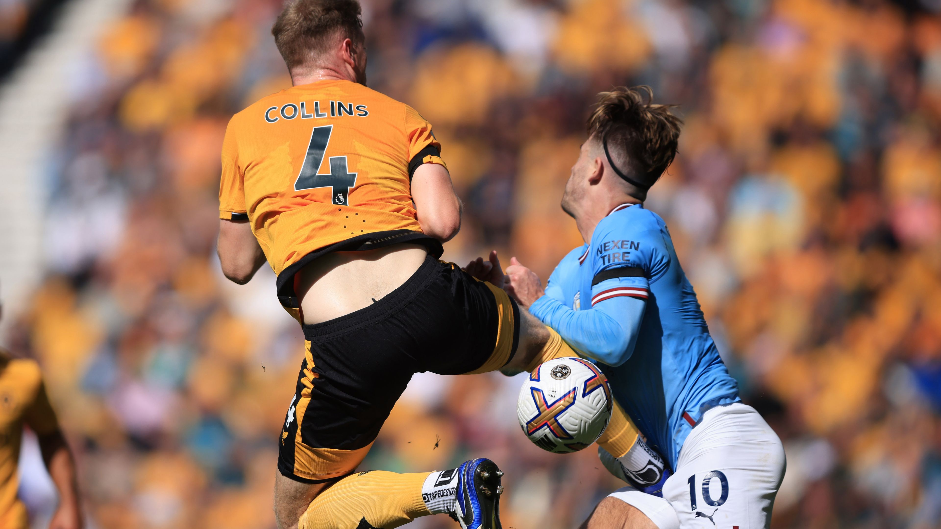 Nathan Collins of Wolverhampton Wanderers is shown a red card for this challenge on Jack Grealish of Manchester City during the Premier League match between Wolverhampton Wanderers and Manchester City at Molineux on September 17, 2022 in Wolverhampton, United Kingdom. (Photo by Marc Atkins/Getty Images)