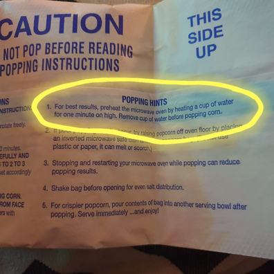 Microwave popcorn instructions to preheat by heating a cup of water for one minute