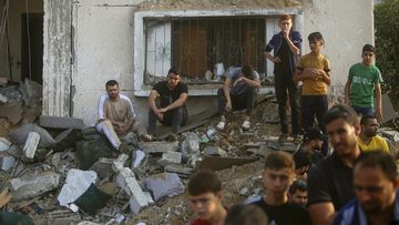 Palestinians inspect the damage of a destroyed house that was hit by an Israeli airstrike in town of Khan Younis, southern Gaza Strip, Tuesday, Oct. 24, 2023.