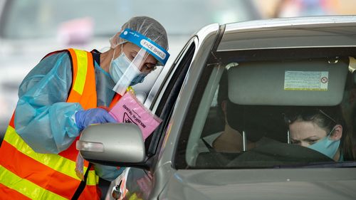 Medical professionals conduct COVID-19 tests at a drive through testing clinic in the Shepparton Sports Precinct in Shepparton, Victoria. 