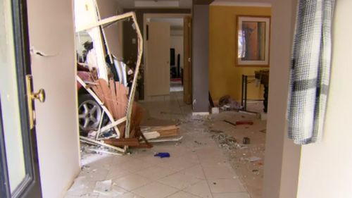 One image captured the car's front wheel wedged in the wall leading to the hallway. (9NEWS)