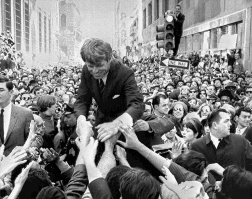 In this April 2, 1968 file photo U.S. Sen. Robert F. Kennedy, D-NY, shakes hands with people in a crowd while campaigning for the Democratic party's presidential nomination on a street corner, in Philadelphia