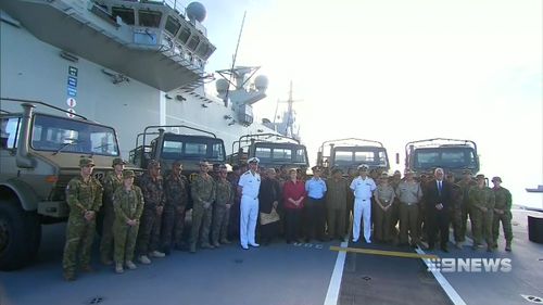 The handing over of the vehicles took place on the HMAS Adelaide. Picture: 9NEWS