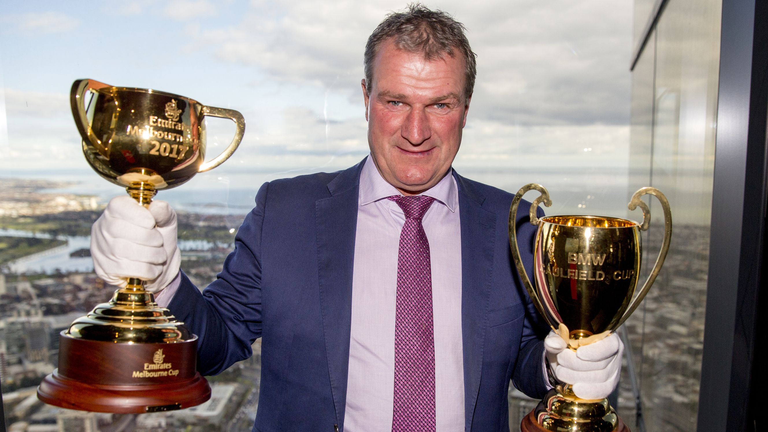 Darren Weir, Melbourne Cup-winning trainer with the 2017 Emirates Melbourne Cup trophy and the    2017 BMW Caulfield Cup trophy at Eureka Tower on August 29, 2017 in Melbourne, Australia. (Fiona Hamilton /Racing Photos)