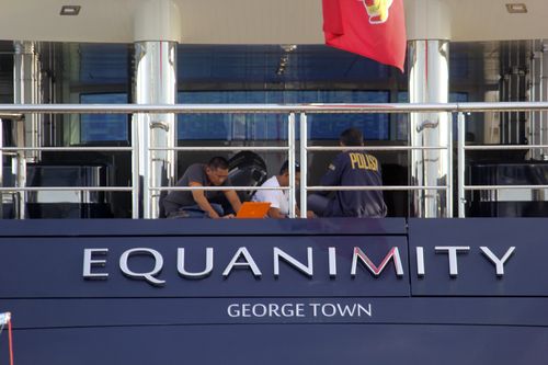 Indonesian police officers are seen on board the luxury yacht 'Equanimity' off Bali island, Indonesia, Wednesday, Feb. 28, 2018. Indonesia has seized the yacht that is wanted by U.S. authorities as part of a probe into alleged multibillion-dollar corruption at Malaysian state investment fund 1MBD. (AP Photo/Yoan Ari)