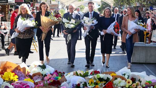 Prime Minister Anthony Albanese, NSW Premier Chris Minns and Allegra Spender lay floral tributes in Oxford Street Mall at Westfield Bondi Junction on April 14 in 2024.