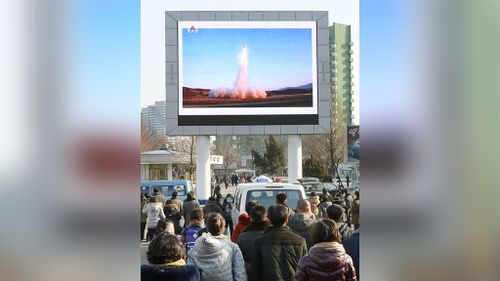 People in Pyongyang watch the news of a test-fire of a new ballistic missile. (AAP)
