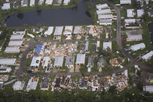 Neighborhoods destroyed by tornadoes are seen in this aerial photo in the aftermath of Hurricane Milton, Thursday, Oct. 10, 2024, in Fort Pierce, Fla. (AP Photo/Gerald Herbert)