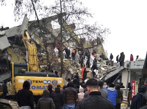 Rescue workers try to reach trapped residents in a collapsed building in Kahta, in Adiyaman province, southeastern Turkey, Monday, Feb. 6, 2023. 