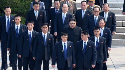 Kim was flanked by security personnel during peace talks with South Korea. (AAP)
