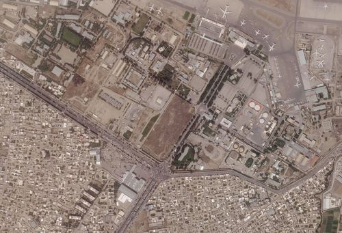 This satellite photo provided by Planet Labs Inc. shows vehicles trying to reach the civilian side of Kabul International Airport, also known as Hamid Karzai International Airport.