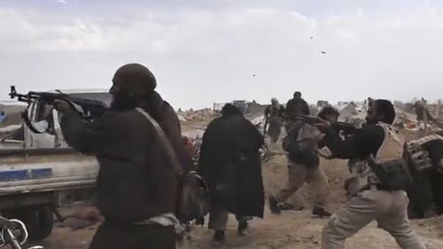Islamic State fighters clash with US-backed Syrian Democratic Forces fighters. Australian cyber units "helped shaped a critical battle" after launching attacks on IS networks.