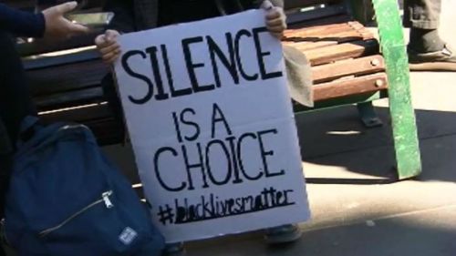 A sign at the rally at the State Library of Victoria. (9NEWS)