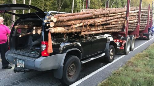 The Department shared photos on Facebook showing the car impaled by the logs.