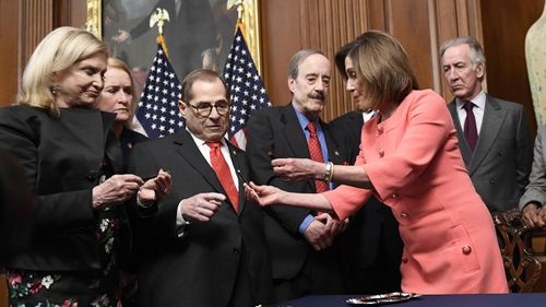 Nancy Pelosi (second from right), gives pens to (L-R) House Oversight and Government Reform Committee Chair Rep. Carolyn Maloney, D-N.Y., Rep. Sylvia Garcia, D-Texas, House Judiciary Committee Chairman Rep. Jerrold Nadler, D-N.Y., House Foreign Affairs Committee Chairman Rep. Eliot Engel, D-N.Y., and House Ways and Means Committee Chairman Rep. Richard Neal, D-Mass., after signing the resolution to transmit two articles of impeachment against Trump (Photo: January 15, 2020)