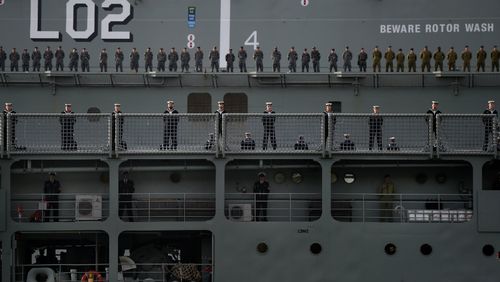 Crew onboard Australia's oldest Naval ship HMAS Tobruk (foreground) are watched by crew onboard Australia's newest naval vessel HMAS Canberra as HMAS Tobruk arrives at Garden Island following her final voyage to her home port in Sydney. Picture: AAP