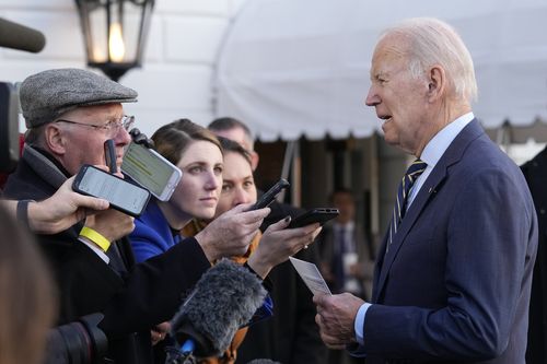 President Joe Biden talks with reporters before he and first lady Jill Biden board Marine One on the South Lawn of the White House in Washington, Wednesday, Jan. 11, 2023.