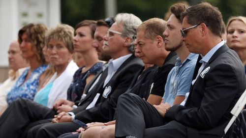 Don Damond, right, sits with family and friends during the memorial service. (AAP)