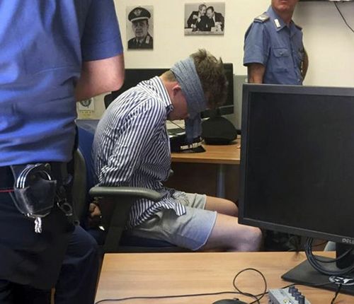 Gabriel Christian Natale-Hjorth sits blindfolded in a police station in Rome on July 26, 2019. Natale-Hjorth is a suspect in the slaying of police officer Deputy Brigadier Mario Cerciello Rega.
