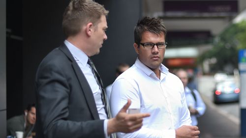 Lawyer Nick Dore speaks with Gable Tostee (right) before entering the Supreme Court in Brisbane. (AAP)