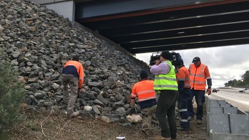 The steel mesh has been installed over 2000 square metres of loose rocks to stop offenders being able to access the deadly objects. (9NEWS)