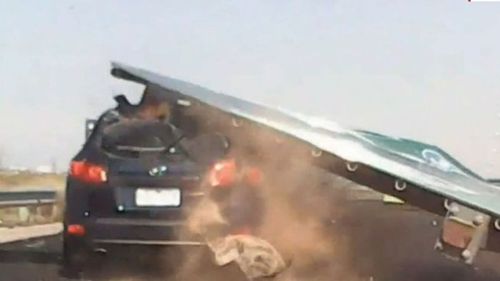 The four-tonne sign crushed the 53-year-old's car with the mother of three lucky to make it out alive.