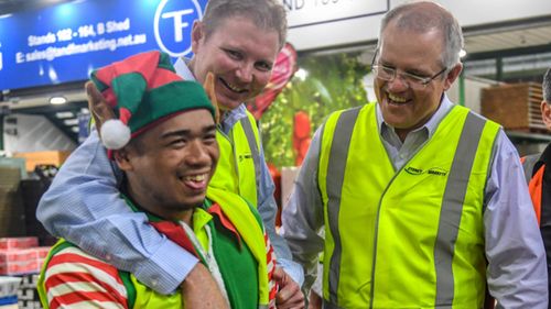 Federal Treasurer Scott Morrison (second right) and member for Reid Craig Laundy (second left) visit the Sydney Markets in Homebush 