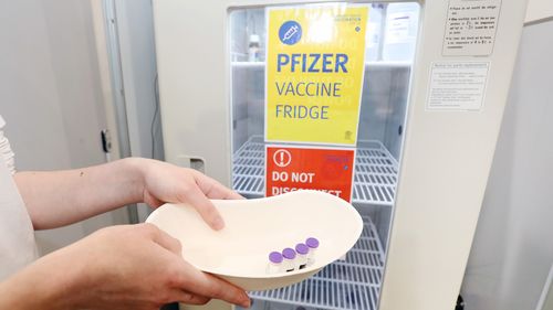 Pharmacy Lead Sarah Spann is seen with Pfizer vials on opening day of the COVID-19 vaccination hub at Brisbane Convention and Exhibition Centre.