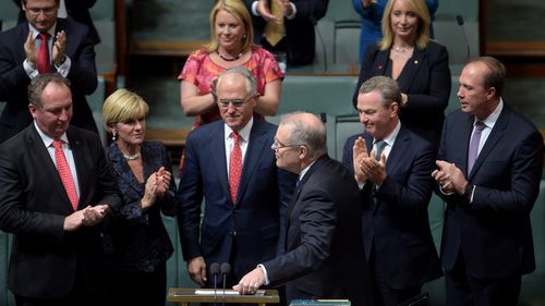 Mr Scott Morrison is congratulated by the PM and his frontbench colleagues after delivering his first budget. (AAP)