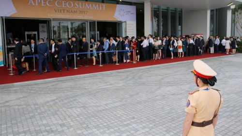 Delegates line up as they queue for a security check before entering the venue of the APEC CEO Summit ahead of the Asia-Pacific Economic Cooperation (APEC) leaders summit in Da Nang, Vietnam on Friday (Image: EPA)