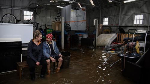 Les Hallack and Haley Lines, who in six months have endured four floods, in Camden, Sydney.