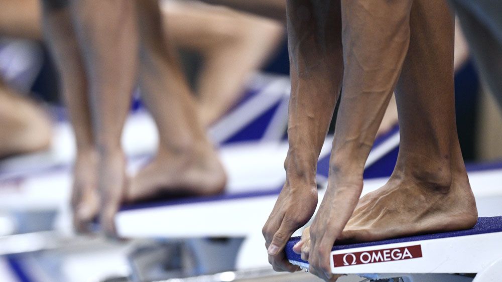 Swimmers line up on the blocks (AFP)