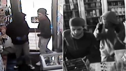 The video shows two men, one armed with a knife and another with a tomahawk leaping over the store counter to raid a cash register. (Supplied)