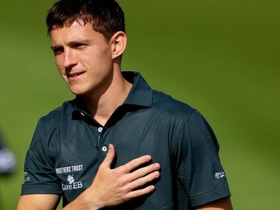 VIRGINIA WATER, ENGLAND - SEPTEMBER 18: Tom Holland acknowledges the crowd on the 18th green during the Pro-Am prior to the BMW PGA Championship 2024 at Wentworth Club on September 18, 2024 in Virginia Water, England. (Photo by Andrew Redington/Getty Images)